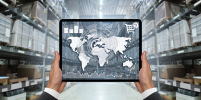 Hands with digital tablet on the background of a warehouse. Onli